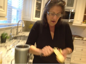 woman peeling a plantain in her kitchen