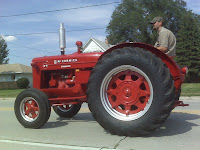 only in a small town parade do you see tractors when there are no floats