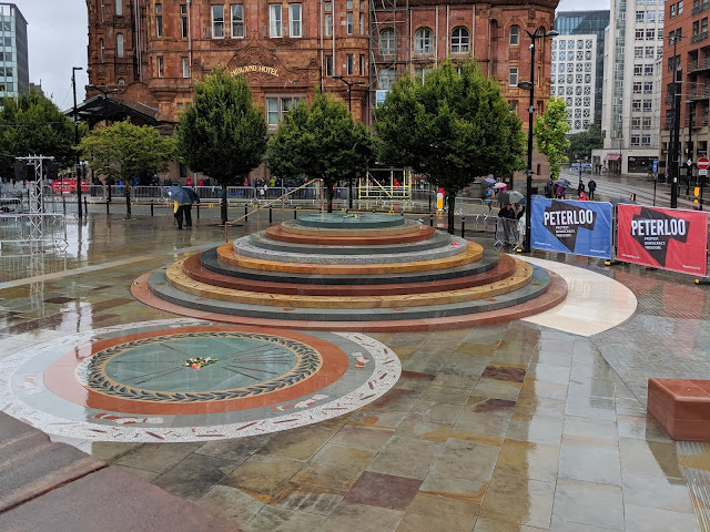 Circular monument on rain soaked pavement