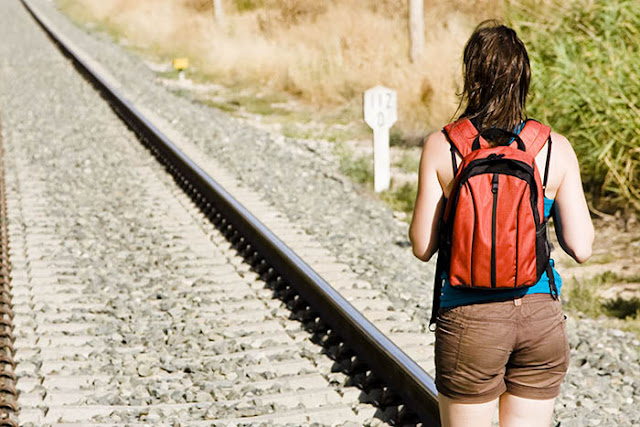 Girl Walking on Train Track