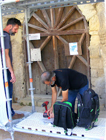 Stone conservators take samples from a church under restoration.  Indre et Loire, France. Photographed by Susan Walter. Tour the Loire Valley with a classic car and a private guide.