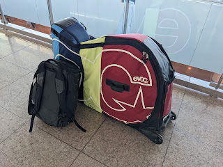 A backpack and a bicycle travel bag at the airport.