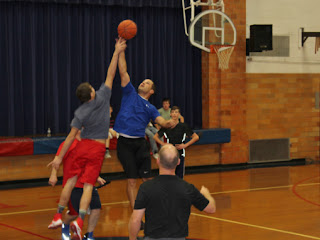 Action shot of two boys jumping for the basketball