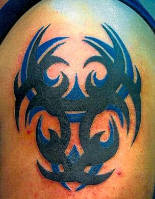 Blue and black ink tribal tattoo