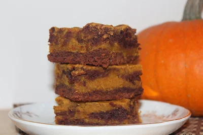 Plate with a stack of pumpkin swirl brownies.