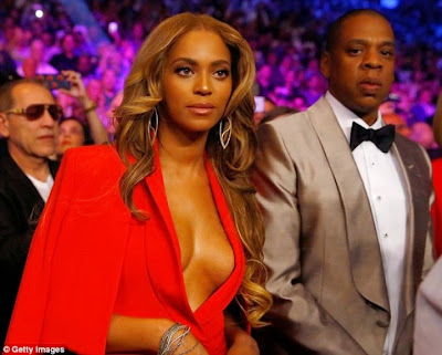 Beyonce flashes boobs at ''Fight Of The Century'' in a red hot cleavage baring outfit 