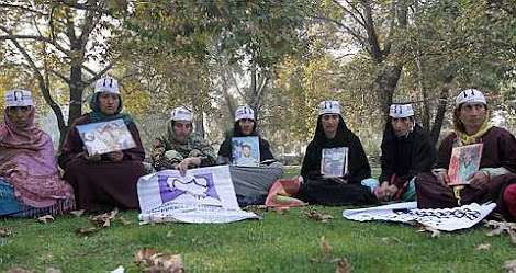 youths hold photographs of their missing family