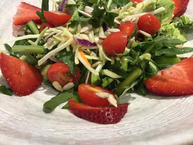 plate of salad with tomato and strawberries