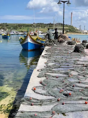 Fishing boats and fishing nets in Marsaxlokk Malta