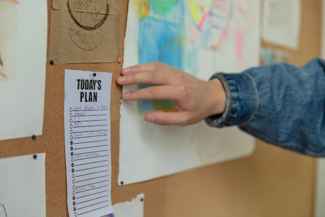 A human hand touching a planner