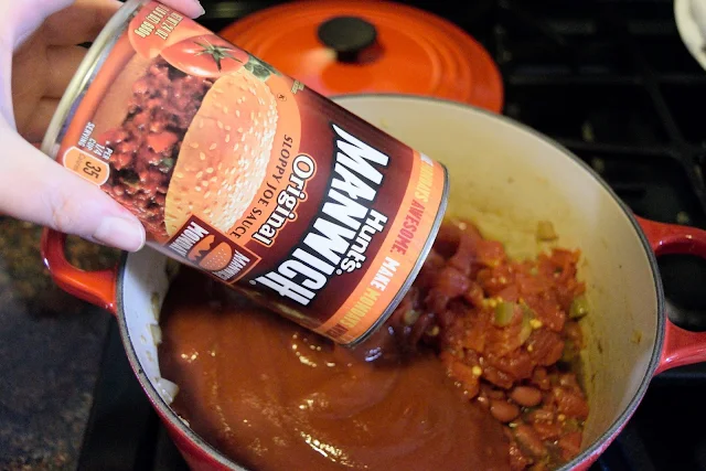 Manwich being added to the pot. 