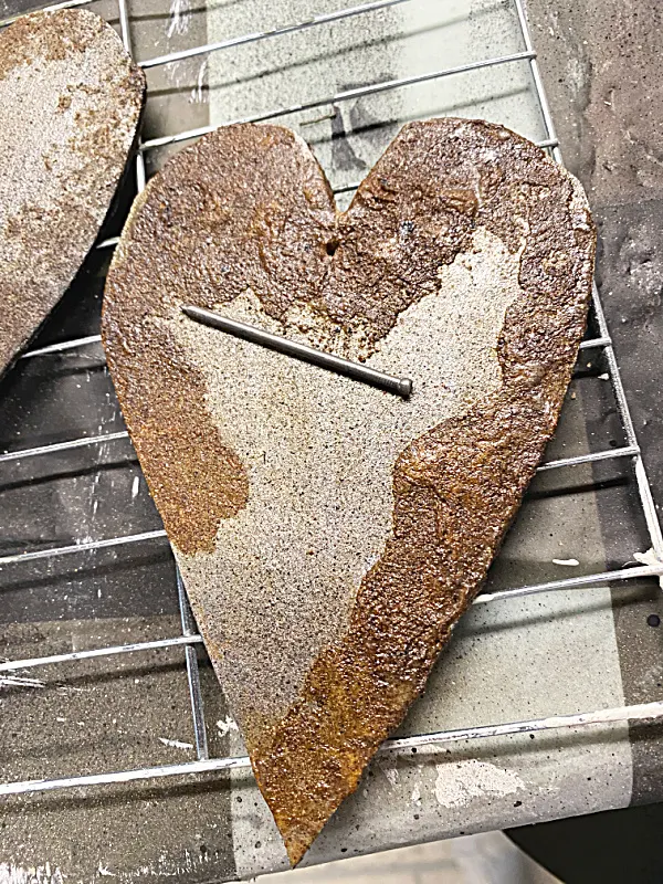 rusty heart with nail