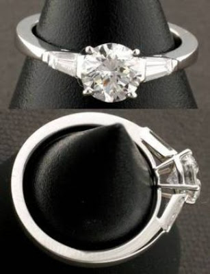 Classic round brilliant diamond solitaire with tapered baguette diamonds