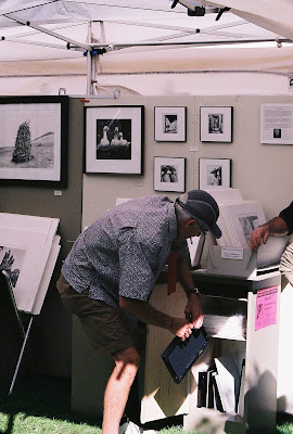 street photography, a photographer peddles his wares