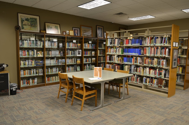 library room featuring South Dakota resources (books) and art.