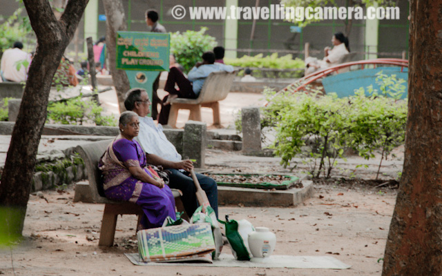 PHOTO JOURNEY inside zoo of Banerghatta National Park Banglore : Posted VJ SHARMA on www.travellingcamera.com : I am sure you will be surprised to hear Zoo and Wildlife Sanctuary at one place... Yes, Banerghatta National Park has a Zoo as well... When I planned for Baneghatta National Park, I was not aware of the fact that it has Zoo as well... After Reaching the ticket counter, I saw a board saying discounted ticket for Wildlife Safari inside the sanctuary and Zoo visit... Banglore Zoo has lot of snakes and most of the crowd is seen around those to figure out where they(snakes) are sitting... Here are few Photographs I was able to click during a quick visit to Banerghatta Zoo... Check out !!!Don't know the name of this bird.. so please do let know in case you know... They were very shy as you can see from the expression in this photograph and there were lot many other birds with various combinations of colors... I had few more photographs of this bird but all were shaky because of lot of movement there... These birds were most active inside the zoo.... Others like snakes, crocodiles, leopards, ducks were really lazy and we couldn't figure out the cause... Even Monkeys were not very active which is a very unusual thing..There were lot many crocodiles inside Banerghatta Zoo and that I saw the height of their laziness... There were few cats inside their court and jumping on their backs.. No Reaction... They used to go near a particular crocodile, check about its activeness by touching the tail and then start all those activities when confirmed that it's not going to hurt them... Many of the folks were standing their for more than 30 minutes to wait for one of the crocodile to take some action, but nothing positive was happening their... and those cats were having fun there :)Sankes - Most popular species inside Banerghatta Zoo.... There was a separate section of various types of snakes and it was naked as snake park inside Banerghatta Zoo... I had never seen these many snakes at one place and there were lot many varieties new for me... It was hard to locate them because many of them were hidden between the branches of the tree or under some rocks etc.. Some of the snakes were 7-10 feet longs and have been playing on bamboo sticks hanging on the trees inside their courts... It seems people don't miss this part of the Zoo during their visit...There was a huge area provided for birds and it was somewhat similar to the Delhi Zoo... Although we were not able to see many birds out there... Also we were very tired after wildlife safari in Banerghatta National Park and didn't want to spend much time to find out more birds there...Many families come to Banerghatta Zoo to enjoy the weekend... I was surprised to see this family with all the stuff like carpet, bat and other stuff... It seems they have come for some picnic but Zoo is not a right place I guess... Ideally eatables and such things should not be allowed inside... I don't have any strong reason for that , but I have seen people making these places dirty... People should think twice before spreading their waste stuff at other's living area... Can they do the same thing inside their house?Oh Yes, I didn't want to miss this particular thing about Banerghatta Zoo... There is a trend of adopting some of the animals of the zoo and many folks have done this... Like this particular Horn bill is adopted by Shri T R Rithvik... This effectively means that Mr. Rrithvik is feeding this Horn bill for some particular duration and probably other costs as well... A nice concept and good idea to support all these rare species  on earth...There was a man outside the zooo who was selling some liquid which creates colorful bubbles... I wanted to capture those bubbles but all I was able to capture was bokeh of all those.... Never mind, I like it :)Rohin Duggal, My friend who made my Banglore trip memorable... Thanks to Rohin !!! btw his girlfriend was out of station and I can tease him by saying that :) On the very first day in Baglore we visited lot many places... Banerghatta national Park, zoo, Butterfly house, MG Road, Bragade Road and UB City ...These folks were wondering why I am clicking a photograph of Rohin... and Rohin asked to click one of their photograph to make them happy... Monkeys inside banerghatta Zoo...Afte completing one round inside Banerghatta Zoo, we had some coconut water in the market outside the zoo... It was amazing, but honestly I didn't like the 'malai' inside it...There are few museums inside the Zoo campus.. Here is one with photographs of various types of birds with some details.... There were lot of school children inside this museum to know about various species of birds and next agenda was to locate them outside....There is a small museum in the zoo which showcases zoological exhibits... Banerghatta Zoo has a reptile park and a small theater as well... Banerghatta Zoo is closed on Tuesdays which is a weekly holiday...