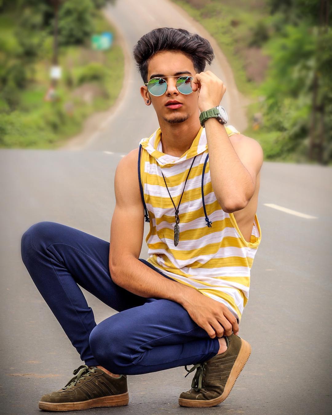 Stylish indian young man photographer at sunglasses wear casual posed  outdoor against iron stairs with dslr photo camera at hands Stock Photo -  Alamy