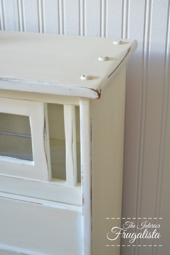 White painted and distressed faux fireplace made from a vintage mid-century modern double headboard.
