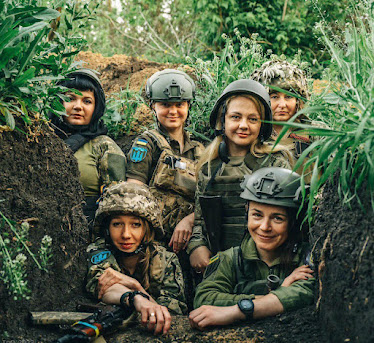 Ukrainian women soldiers in dense undergrowth