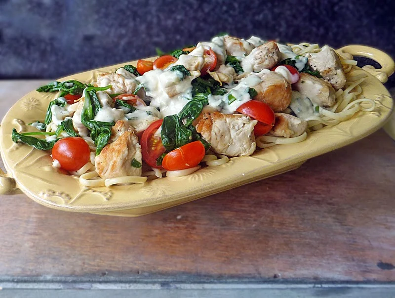 Chicken Florentine Pasta Recipe | by Life Tastes Good is chicken, spinach, tomatoes on a bed of linguine topped with a deliciously cheesy Mornay sauce! #Italian #Pasta #Sauce