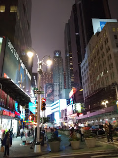 Typical New York City, busy, tall buildings, everything lit up