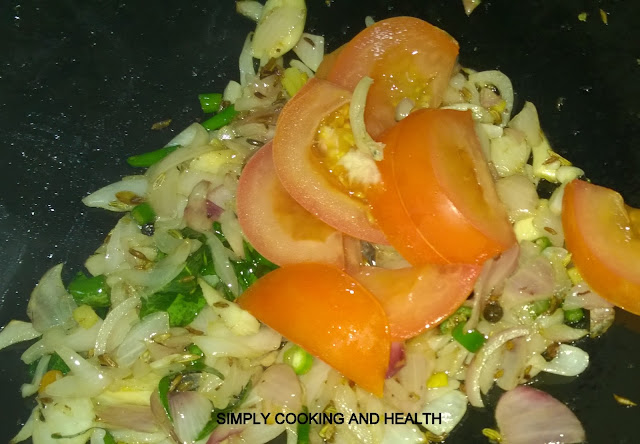 Frying cumin fennel seeds,onion,garlic tomato chili,curry leaves