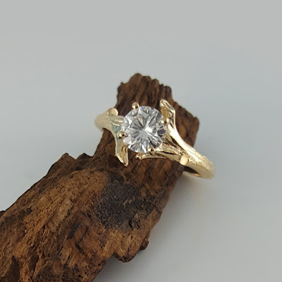 This is my original bud branch design with a 6.5 mm moissanite stone from the forever brilliant collection from Charles & Colvard. This listing is for two rings, an engagement ring and coordinating band. These rings are solid 14k or 18k gold. The rings also come with a certificate for the moissanite stone from Charles & Colvard.