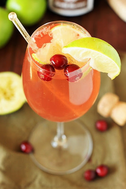 Sparkling Cosmopolitan Image ~ Perfect for girls' night in, brunch, or a random Tuesday.  Or, with it's beautiful cranberry base and garnish, for Thanksgiving sipping, too