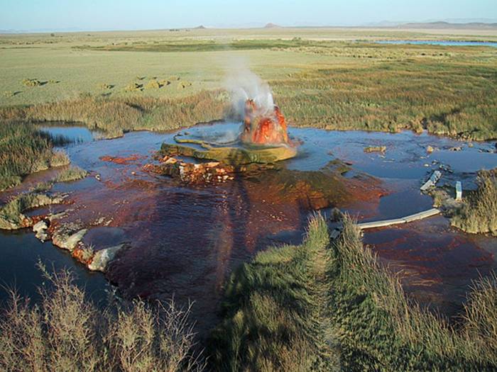 Fly Geyser is a little-known tourist attraction, even to Nevada residents. It is located near the edge of Fly Reservoir and is only about 5 feet (1.5 m) high, (12 feet (3.7 m) counting the mound on which it sits). The Geyser is not an entirely natural phenomenon, and was accidentally created in 1916 during well drilling. The well functioned normally for several decades, but in the 1960s geothermally heated water found a weak spot in the wall and began escaping to the surface. Dissolved minerals started rising and accumulating, creating the mount on which the geyser sits, which continues growing. Today water is constantly spewing, reaching 5 feet (1.5 m) in the air. The geyser contains several terraces discharging water into 30 to 40 pools over an area of 30 hectares (74 acres). The geyser is made up of a series of different minerals, which gives it its magnificent coloration.