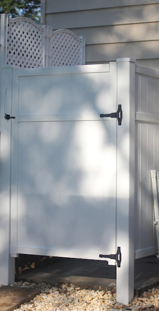 DIY outdoor shower using PVC fence panels via www.goldenboysandme.com