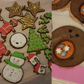 on the left side there are a variety of iced biscuits in festive shapes like snowmen and trees. On the right is a failed glass belly robin biscuit, the "glass" centre is orange but has seeped out from the centre.