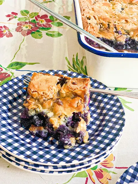 These delightful Blueberry Gooey Butter Cake Bars have the perfect combination of flavors, the ease of the recipe, and the ease of carrying it somewhere.   Perfect for any celebrations, picnics, potlucks, or grand enough for any dinner party.