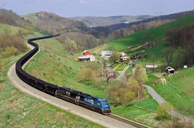 A weathered ExConrail Dash-8 train fills the quiet green valley the Manor Branch at Time in Pennsylvania 