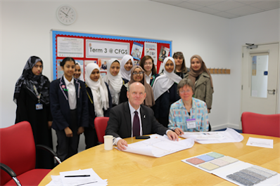 Mayor John Biggs, Cllr Val Whiteread and pupils look at traffic calming plans