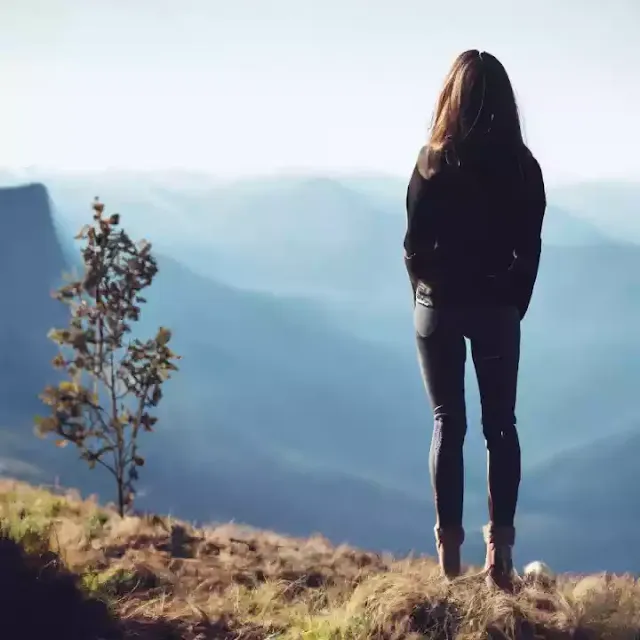 Girl standing on Mountain top