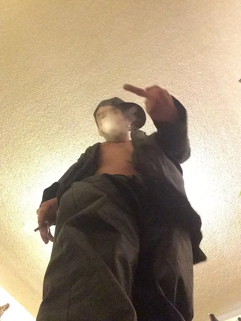 OregonLeatherboy standing Superior POV giving the middle finger wearing leather pants shirtless blowing out smoke