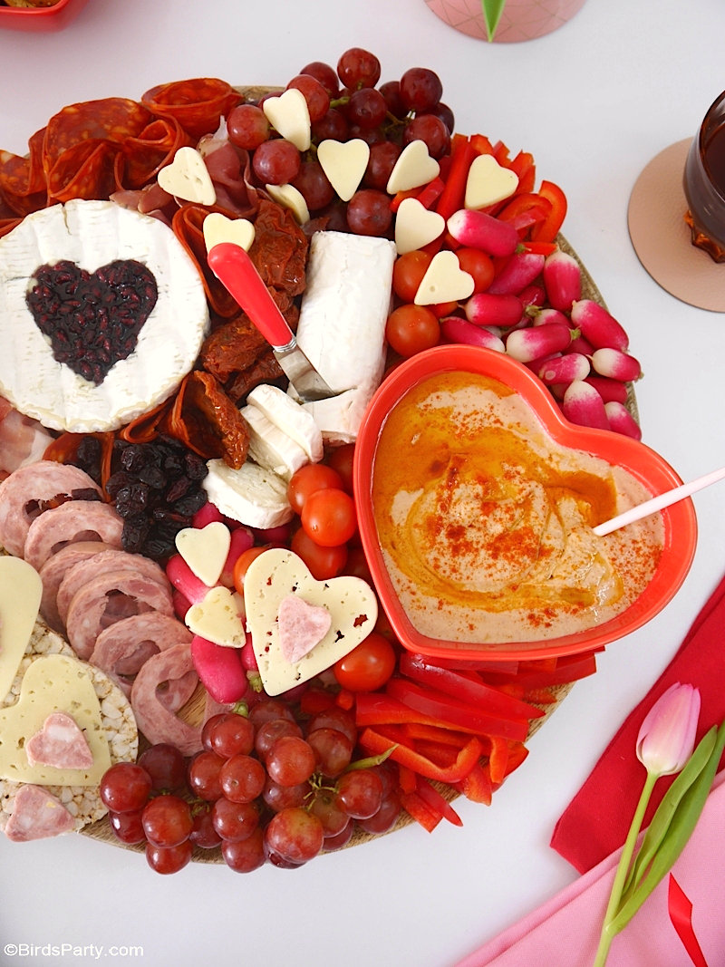 Valentine's Day Cheese and Charcuterie Board - easy, pretty, delicious grazing board filled with pink & red foods to celebrate love day at home! by BirdsParty.com @birdsparty #cheeseboard #charcuterieboard #valentinesday #recipes