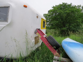 weight against the side of a flexible fiberglass trailer