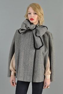 Vintage 1980's grey wool herringbone cape with big bow tie closure at neck and black contrast trim.