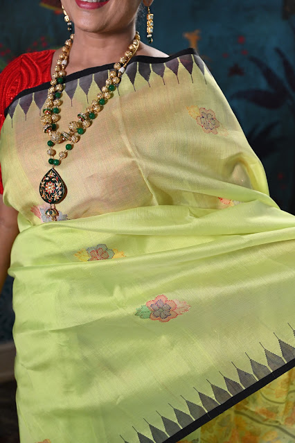 Lime green Rani phee silk jamdani saree with a temple border from Manipur.