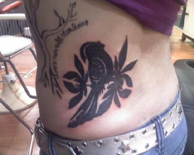 Lower Back Tattoo with Bird Tattoo Picture that's full of Black Ink