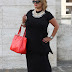 Total black with a red bag and a statement necklace