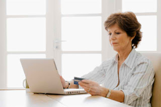 old woman holding credit card