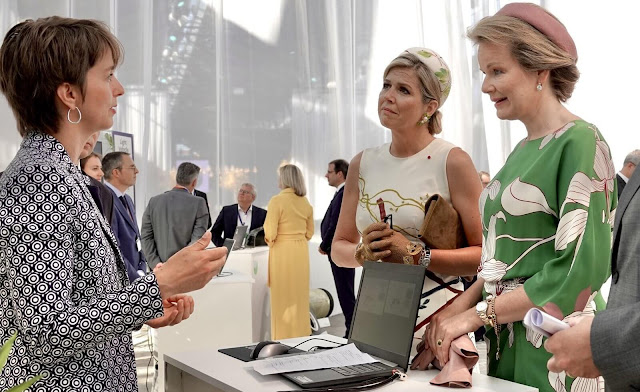 Queen Maxima wore a hand-painted silk and cotton shantung dress by Natan. Queen Mathilde wore a floral print maxi dress by Natan