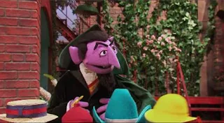 Count von Count sets up today's theme of counting by counting some sentient hats that stop by. Sesame Street Episode 5015, There’s a New Count in Town, Season 50.