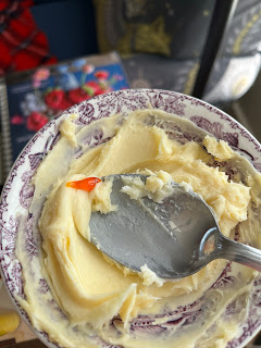 Mixing buttercream in a small dish with foodcoloring