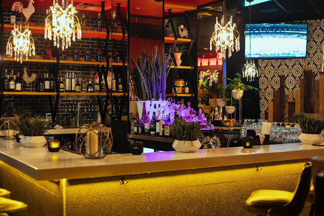 A fully-stocked bar with LED strip lights and neon LED light effects.