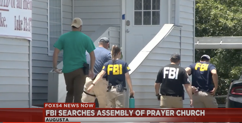 Agents outside the Assembly of Prayer Church near Fort Gordon on Thursday