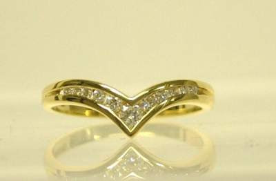 gold wishbone shaped ring set brilliant cut diamonds