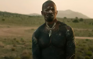 a man with tattoos on his chest.
